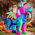 Inflatable alebrije creature covered in bright pink, blue and yellow folk-art patterns beside pumpkins