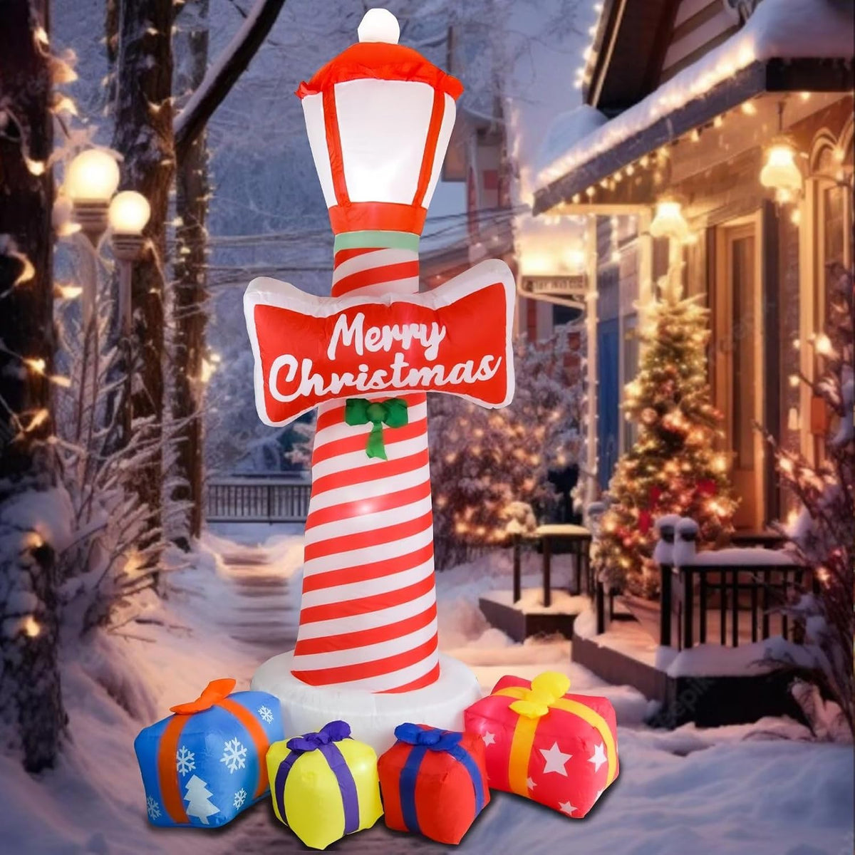 Inflatable red and white striped lighthouse with a Merry Christmas sign and colorful gift boxes