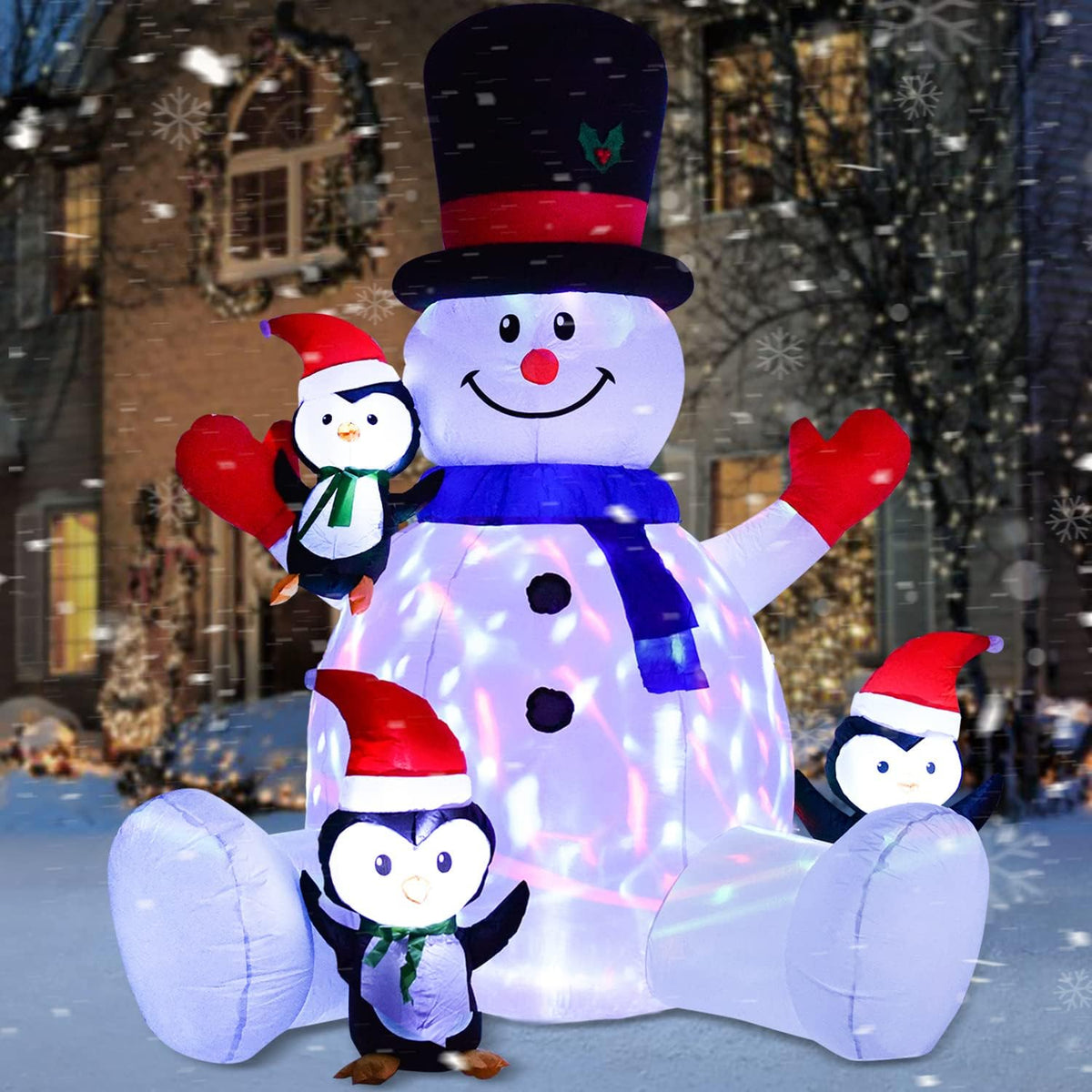 Inflatable snowman in a black top hat with three penguins in Santa hats glowing blue and pink