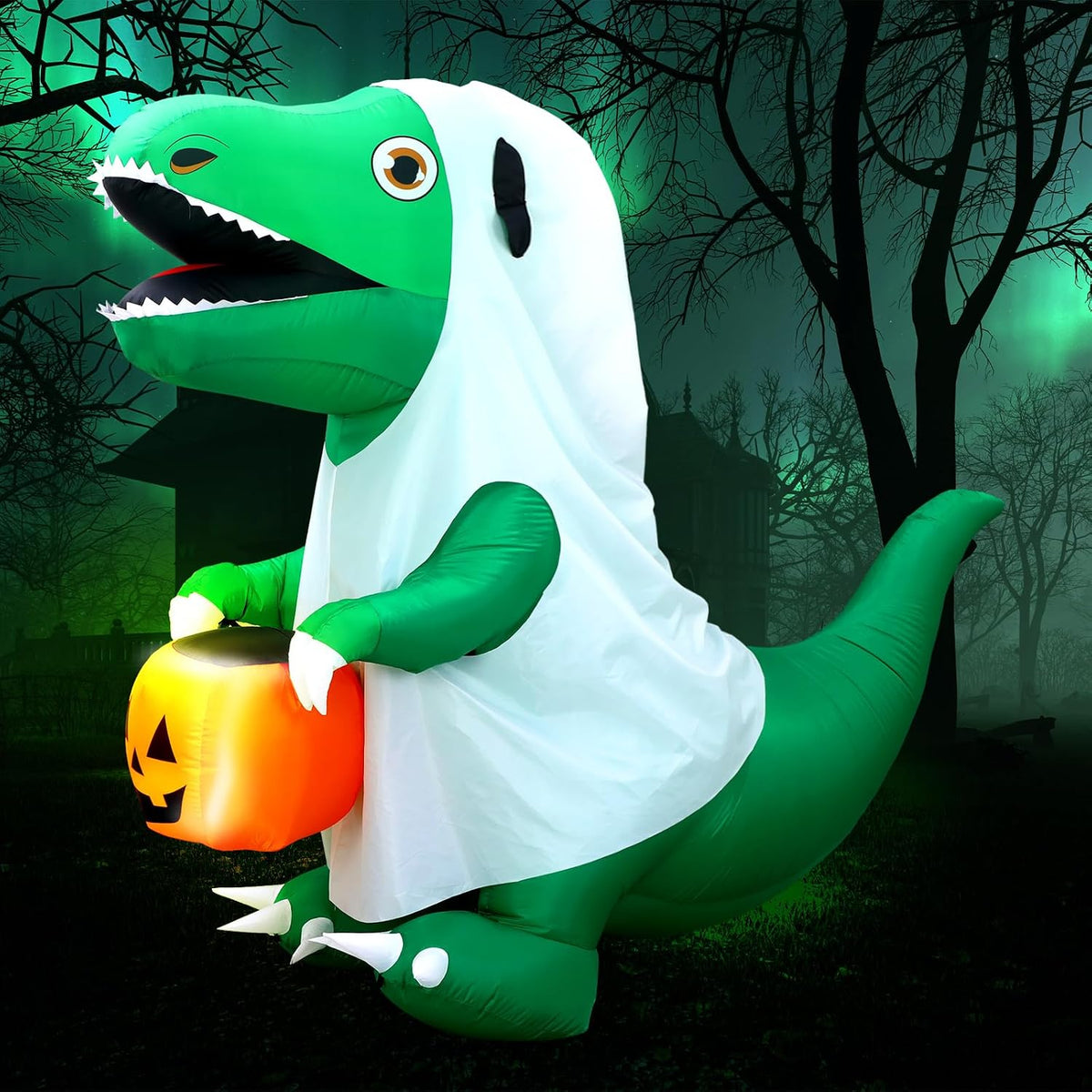 Inflatable green dinosaur wearing a white ghost sheet and holding a jack-o'-lantern in a dark yard