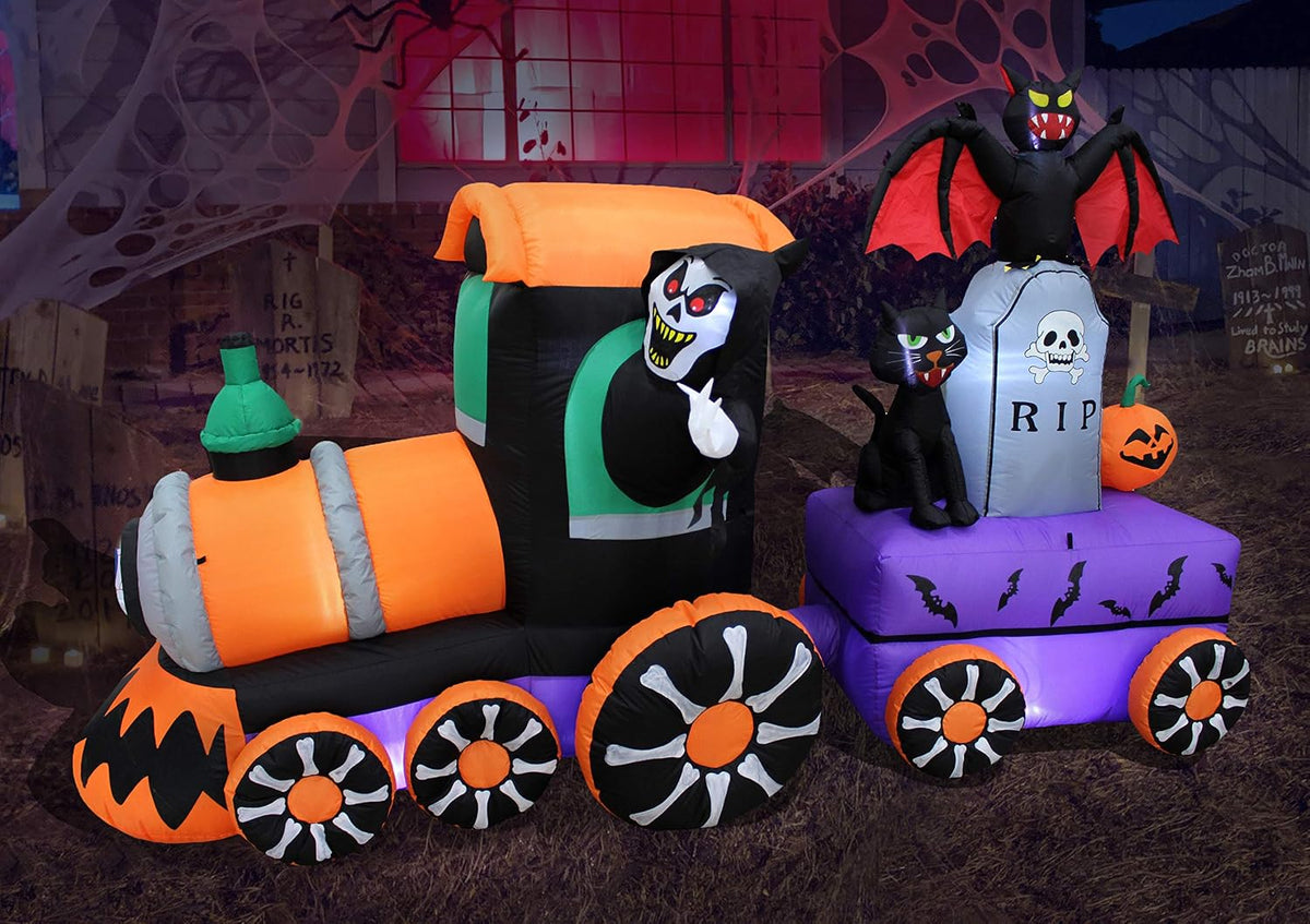Inflatable Halloween train with a grim reaper, pumpkin wheels, a tombstone car and a black cat