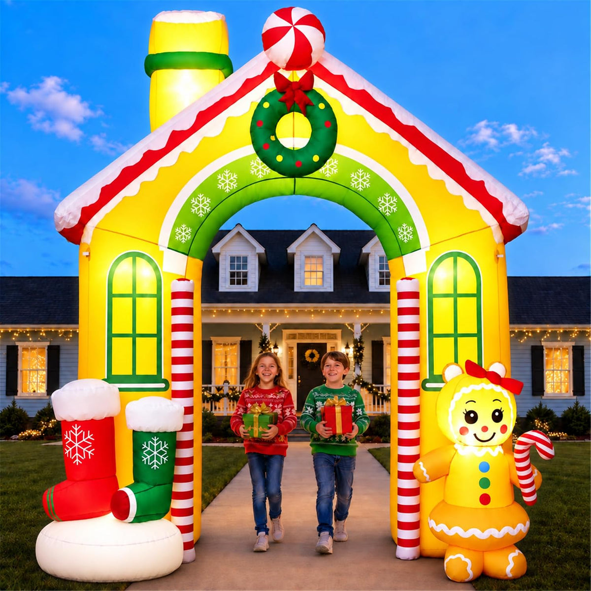 Inflatable gingerbread house archway with a wreath and candy trim, a family walking through
