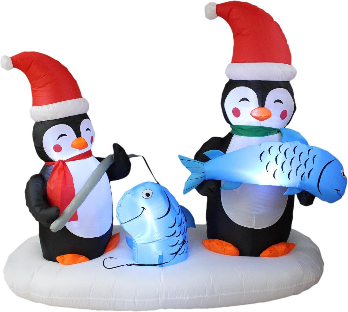 Inflatable scene of two penguins in Santa hats ice fishing, one holding a blue fish