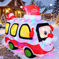 Inflatable holiday bus with Santa at the wheel glowing with colored lights in a snowy street