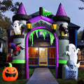 Tall inflatable haunted mansion archway with purple spires, green slime and ghosts on a front path