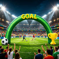 Green inflatable soccer archway with a GOAL banner, a ball and a gold trophy on a stadium field