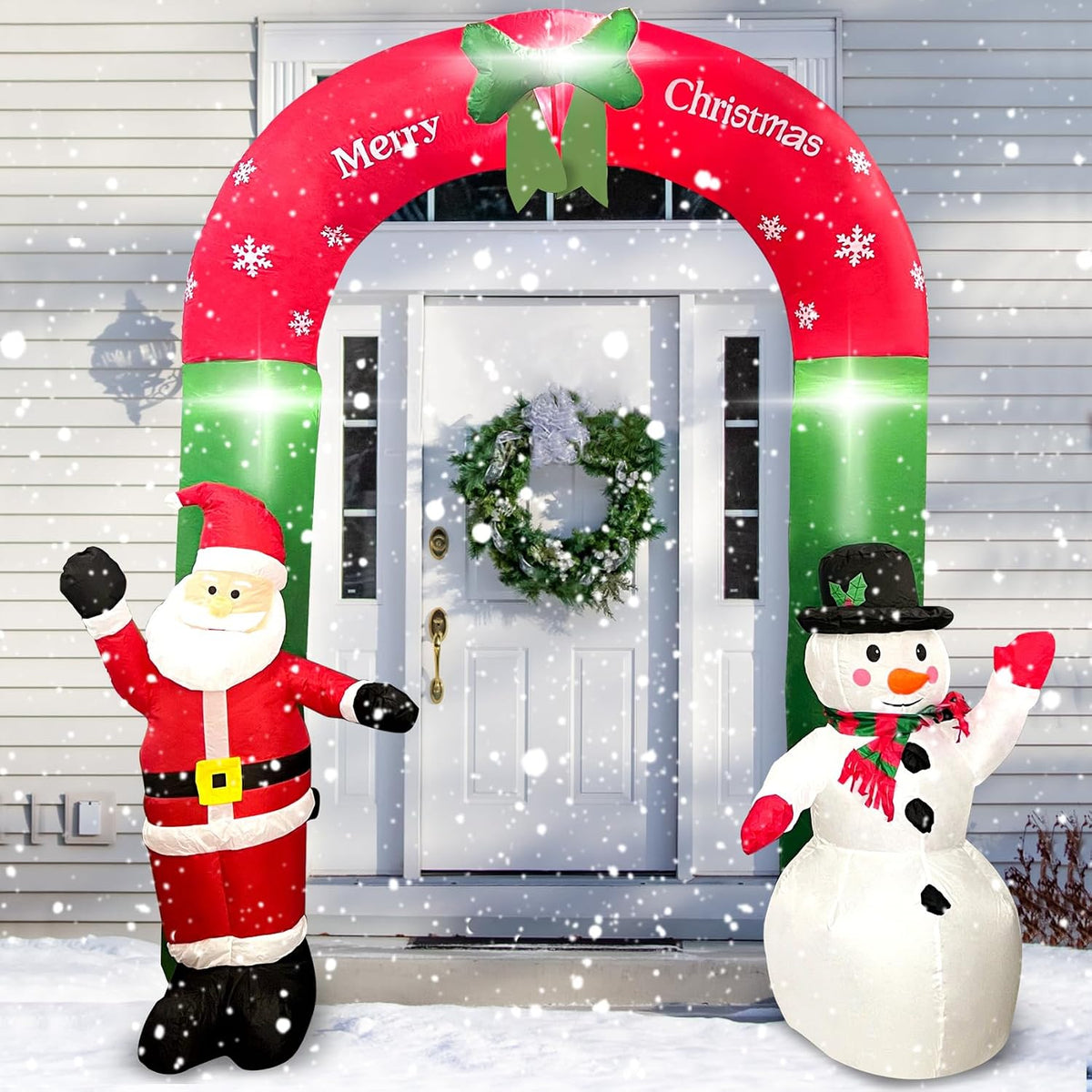 Inflatable red and green Christmas archway over a front door with Santa on one side and a snowman on the other