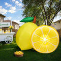 Giant inflatable yellow lemon and lemon slice beside a lemonade stand in a garden