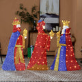 Three pre-lit 2D wise men figures in blue, red and gold robes carrying gifts