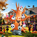 Inflatable haunted orange tree with skull faces and a grey skeleton dog in a Halloween yard