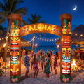Inflatable tiki archway with an ALOHA sign lit up at a beach party at night